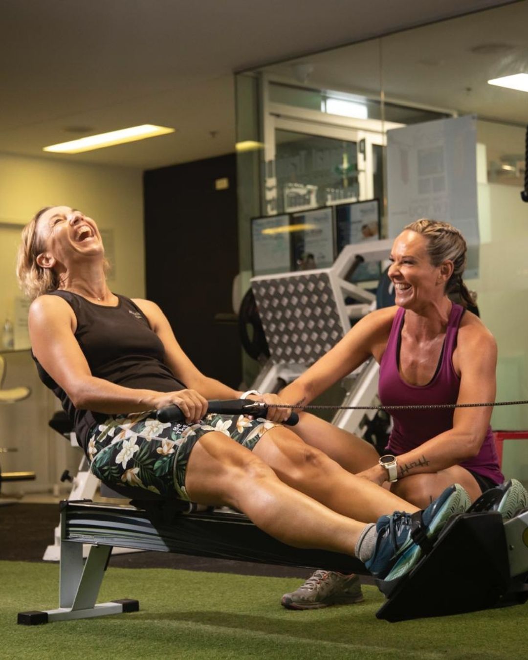 Brisbane fitness trainer and neuro-transformation therapy coach laughing with her client in a coaching session